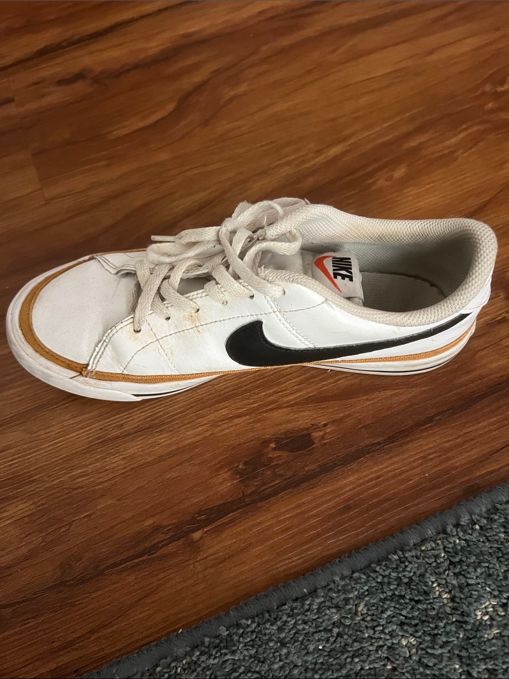 Nike Kids White Sneaker with Black Swoosh and Tan Accent
